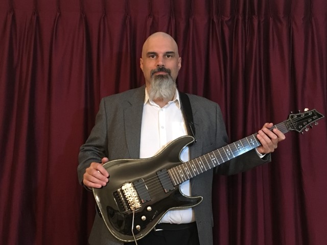 Matthew Ruggiero posing with guitar
